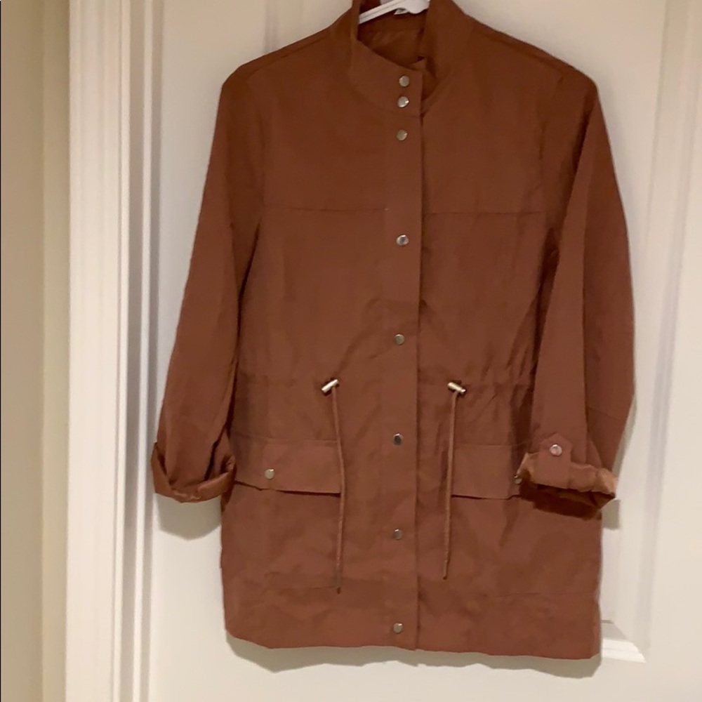 Rose colored jacket with some brown tones.